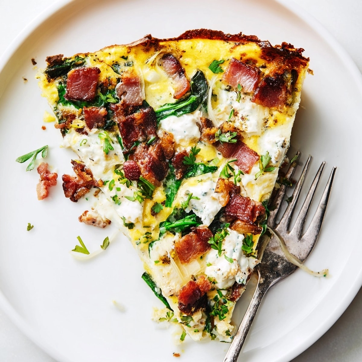 Ricotta herb bacon frittata baking in a skillet, golden brown, bubbling, and ready to serve.