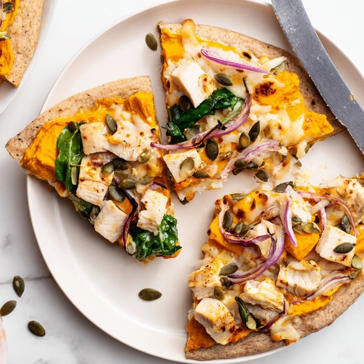 Scoopable Protein Pumpkin Ricotta Pizza shows savory autumn colors and delicious topping details.
