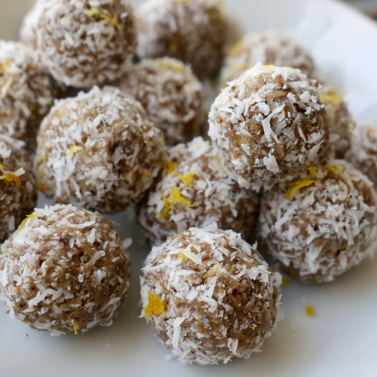 Zesty Holiday Snack Lemon Ginger Balls coated in coconut, perfect for festive gatherings.  