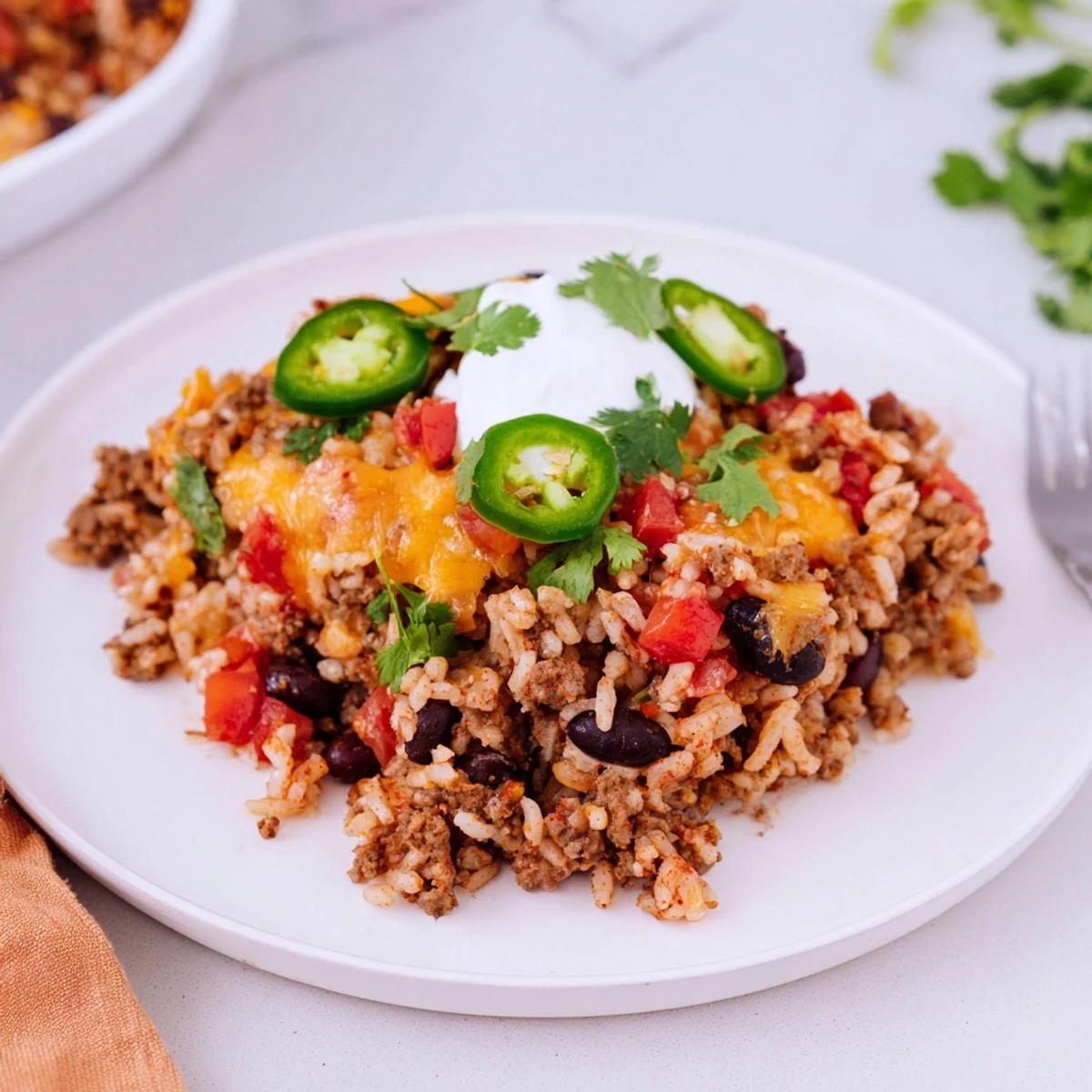 Savor the comforting Tex-Mex Beef & Rice Casserole, bursting with flavors and textures.  