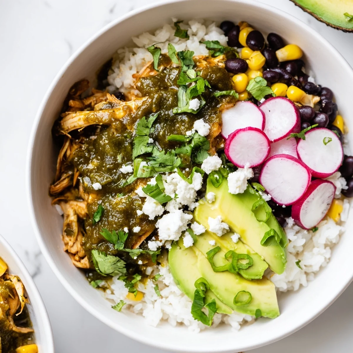 A delicious, colorful Green Enchiladas Rice Bowl, showcasing fluffy rice topped with flavorful chicken and fresh cilantro.