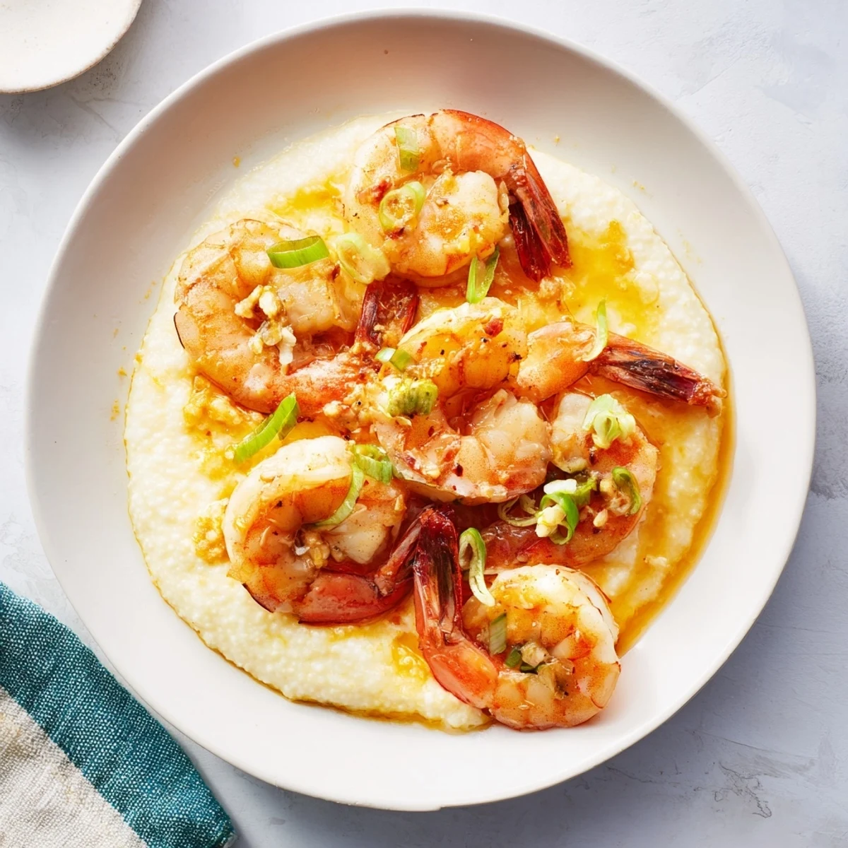 Fresh parsley and scallions garnish savory Shrimp & Grits, a flavorful Southern brunch or dinner idea.