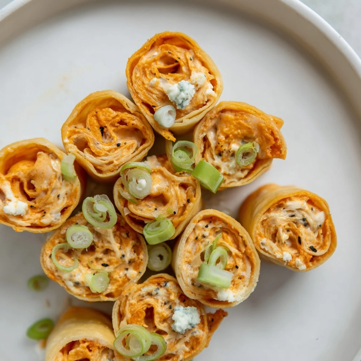 Golden, crispy Buffalo Chicken Dip Pinwheel Wonton appetizers, perfect for game day snacking and parties.