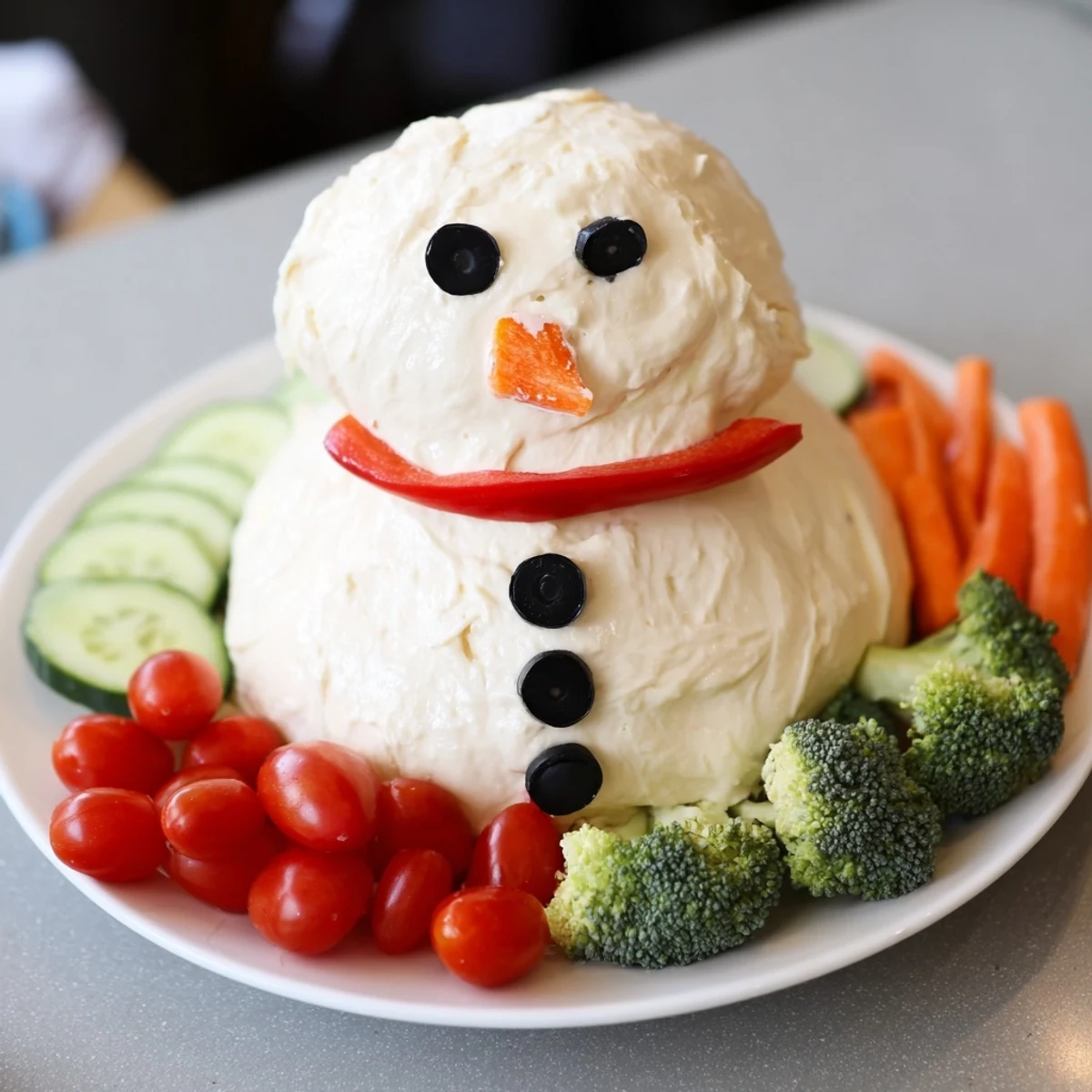 Festive Snowman Veggie Dip, with colorful carrot nose and red pepper scarf, ready to enjoy with friends.