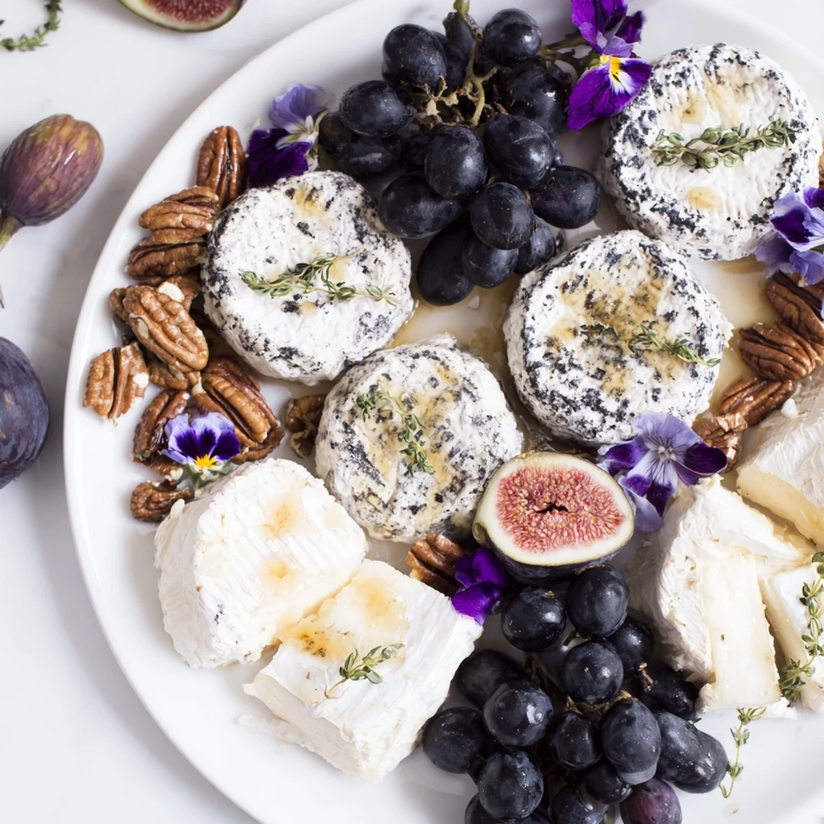 Elegant The Lavender Haze appetizer cheese board, showcasing lavender goat cheese, fruits, and crackers for serving.