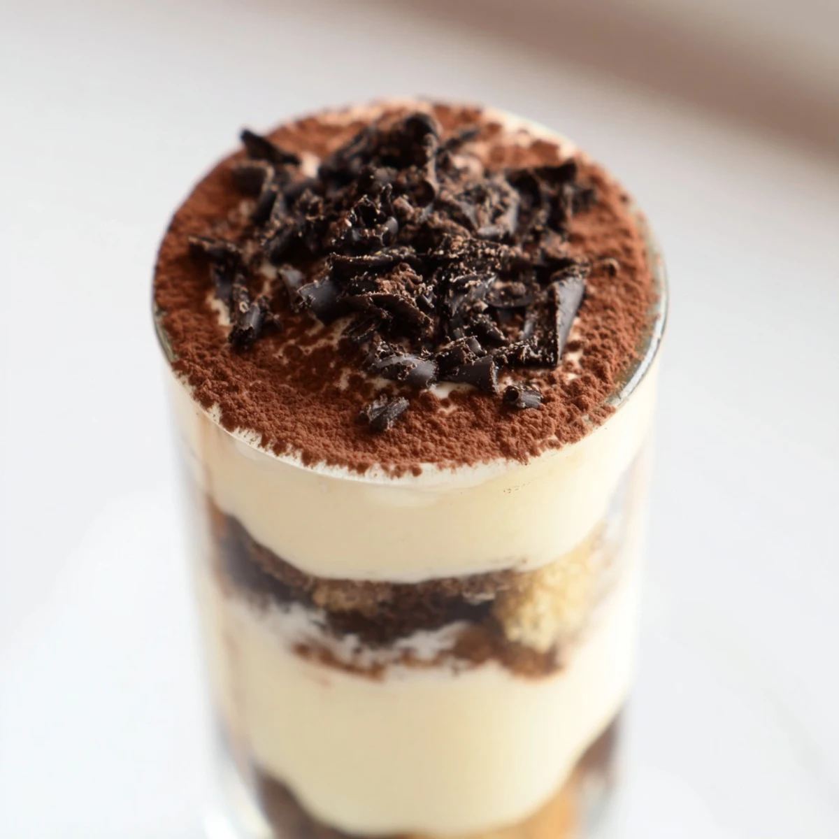 Deconstructed Tiramisu Shots: layers of espresso-soaked ladyfingers beneath creamy mascarpone, ready to enjoy.