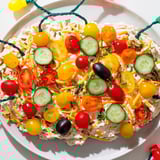 A festive holiday display of Christmas Lights Appetizer, bursting with colorful veggies and creamy cheese.