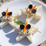 These irresistible Mini Starfish Sandwiches feature olive eyes and caper details, ready for a party.