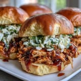 2. Juicy slow-cooked pulled chicken smothered in tangy BBQ sauce, topped with creamy coleslaw.  