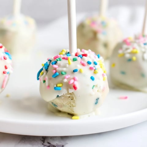 Lightened-Up Sugar Cookie Cake Pops, a decadent dessert, beautifully coated and ready to enjoy.