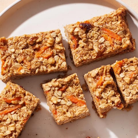 Warm, homemade Peanut Butter Carrot Cake Oat Bars fresh from oven on parchment.