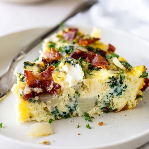 Close-up of a creamy Ricotta Herb Bacon Frittata slice; fragrant herbs, rich bacon visible.