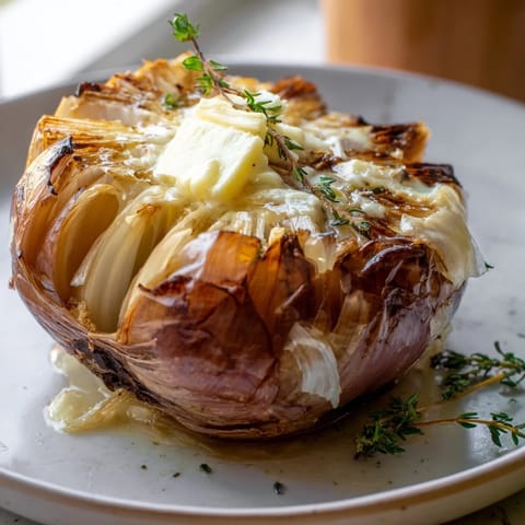 Savory onion boil: the soft, sweet, roasted onions are topped with herbs and a pat of butter, ready to eat.