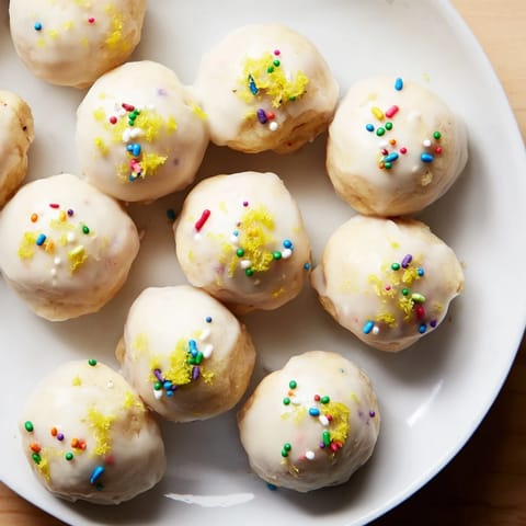 Golden-brown Protein-Packed Italian Christmas Cookie Balls drizzled with sweet glaze and colorful sprinkles.