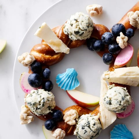 Delicious Anchor Maritime Board, featuring creamy cheeses, fruits, and snacks for a party appetizer.