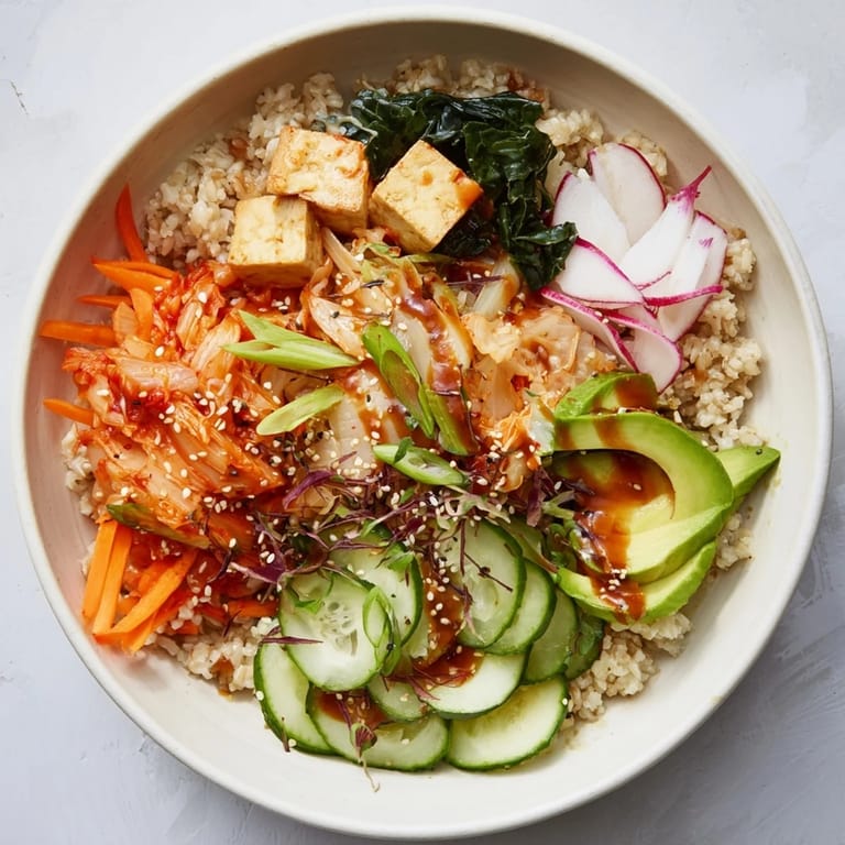 Colorful bowls filled with kimchi, grains, and seasonal vegetables for a healthy meal.  