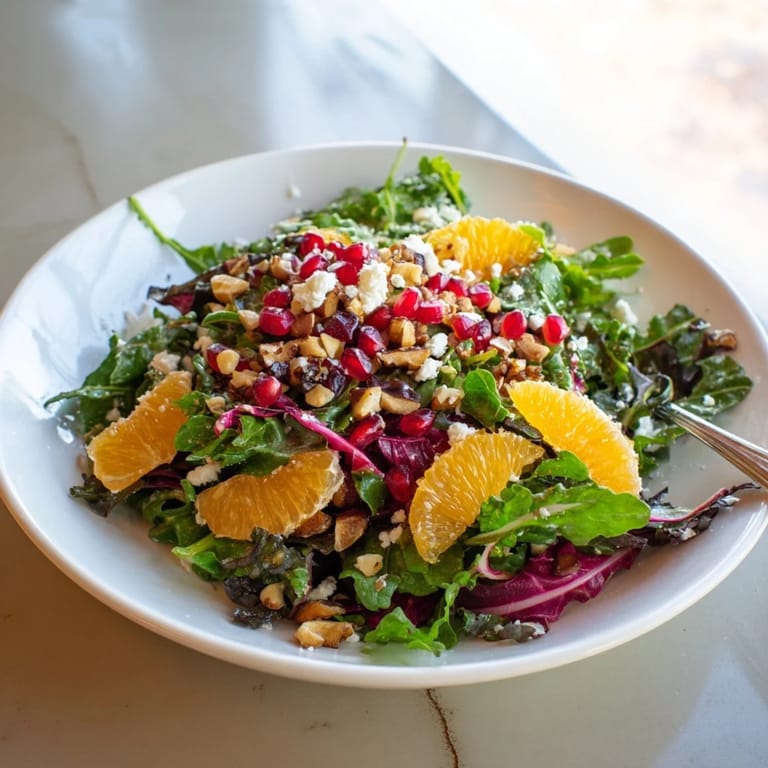 Bright, refreshing Winter Greens Salad with Citrus, featuring juicy citrus and ruby pomegranate, looks so appetizing.