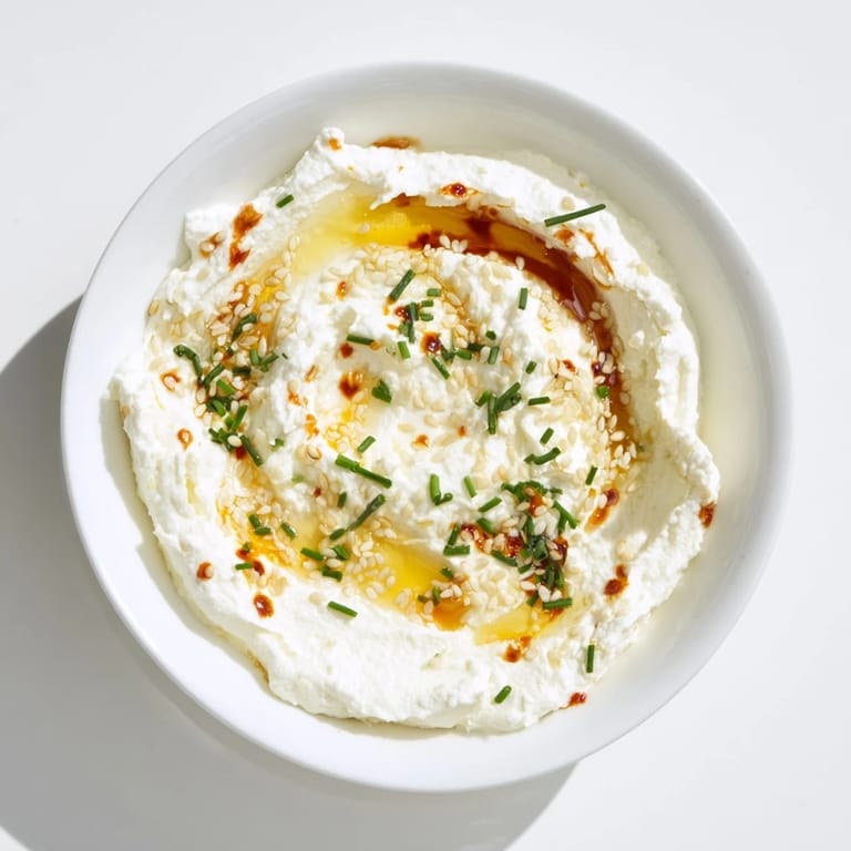 A beautiful close-up of the whipped ricotta dip drizzled with spicy, amber-colored hot honey.