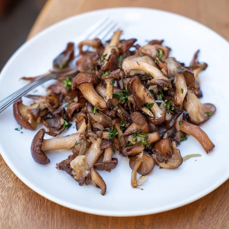 A close-up view of flavorful Enchanted Forest Mushrooms, sautéed to perfection with garlic and thyme.