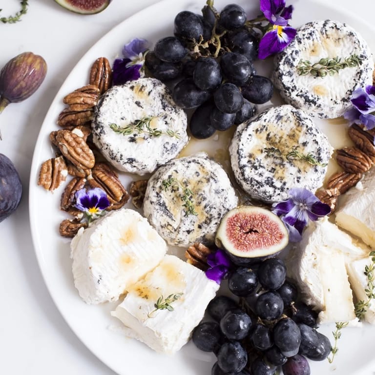 Elegant The Lavender Haze appetizer cheese board, showcasing lavender goat cheese, fruits, and crackers for serving.