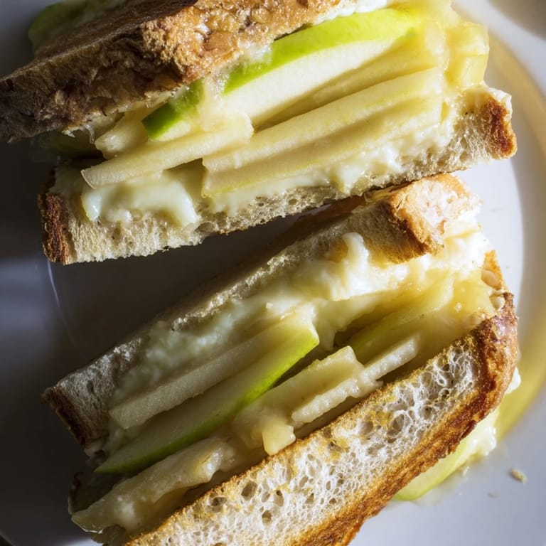 Perfectly grilled Brie and Apple Grilled Cheese, featuring a gooey, cheesy interior and crunchy bread.