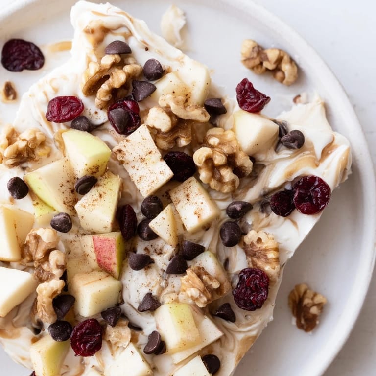 Cool, creamy Apple Cinnamon Yogurt Bark, a healthy frozen treat, showcasing a sprinkle of cinnamon on top.