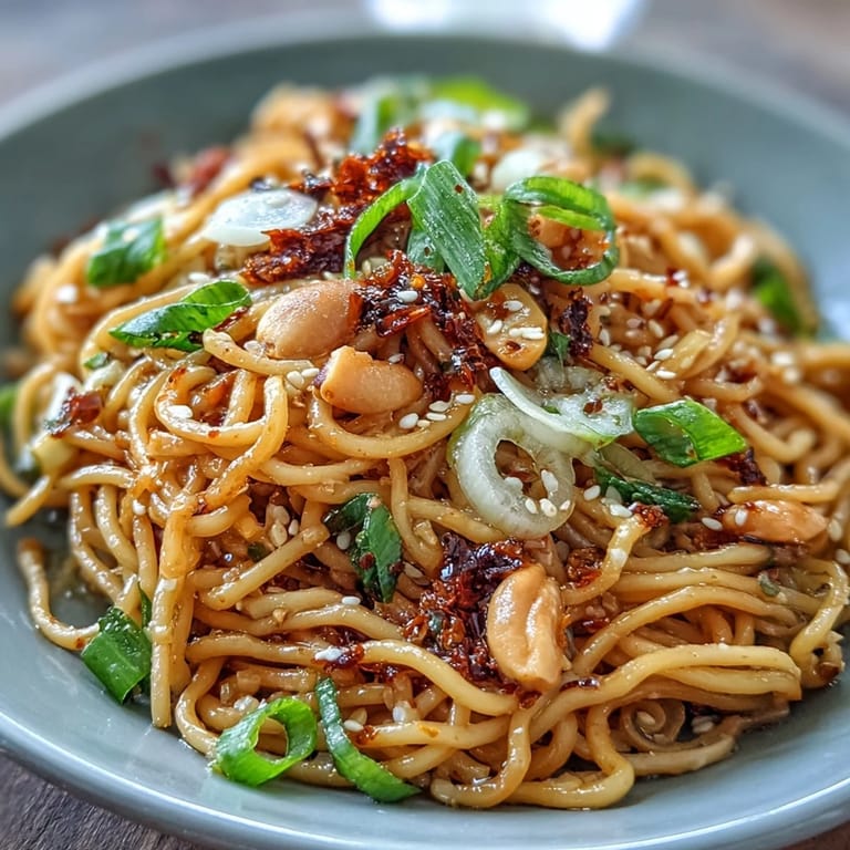 Aromatic Chili Crisp Noodles served hot, featuring chewy wheat noodles tossed in chili crisp sauce, garlic, and crisp vegetables for a satisfying Asian-inspired meal.