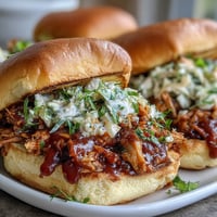 Smoky BBQ Pulled Jackfruit Sandwiches, piled high with tangy coleslaw.